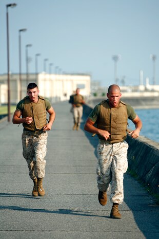 Lance Cpl. Alex H. Potter works to stay ahead of Lance Cpl. Zachary H. Lama in the last leg of the three-mile run on the seawall here during the Super Physical Fitness Test put on by Headquarters and Headquarters Squadron June 17. The Marines were competing for a chance to ride in the backseat of an F/A-18 fighter jet in an upcoming deployment.