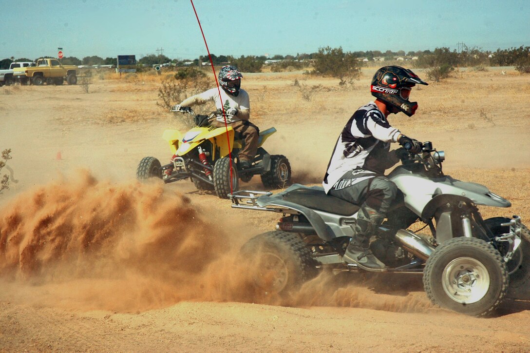 Cpl. Thomas Mango, left, and Staff Sgt. Darrin Minderman practice turning at Fortuna Wash in Yuma, Ariz., on June 17, 2009, during the first basic all-terrain vehicle riders course held by the safety department at the Marine Corps Air Station in Yuma. The course taught Marines who ride ATVs techniques to improve their riding abilities as well as how to lessen their impact to the environment.