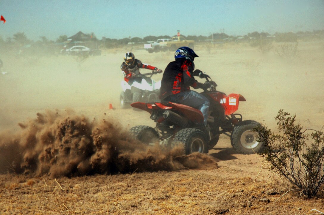 Gunnery Sgt. Gerardo Guzman, left, and Cpl. Paul Peterson practice turning at Fortuna Wash in Yuma, Ariz., on June 17, 2009, during the first basic all-terrain vehicle riders course held by the safety department at the Marine Corps Air Station in Yuma. The course taught Marines who ride ATVs techniques to improve their riding abilities as well as how to lessen their impact to the environment.