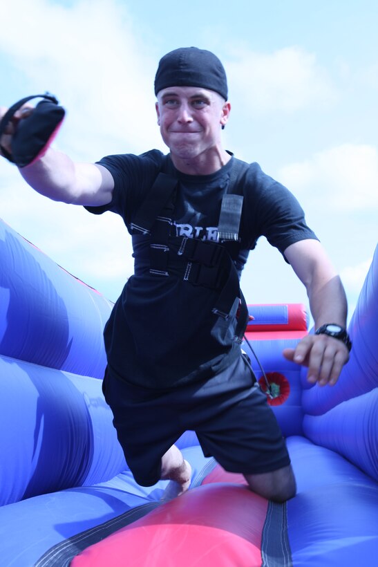 A Marine with 3rd Battalion, 6th Marine Regiment, 2nd Marine Division tests his mettle on the bungee run ride at the unit’s Summer Safety Family Fun Day, June 18.  ::r::::n::
