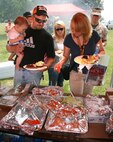 A family goes through the food line at the Command's Family Fun Day in 2009.