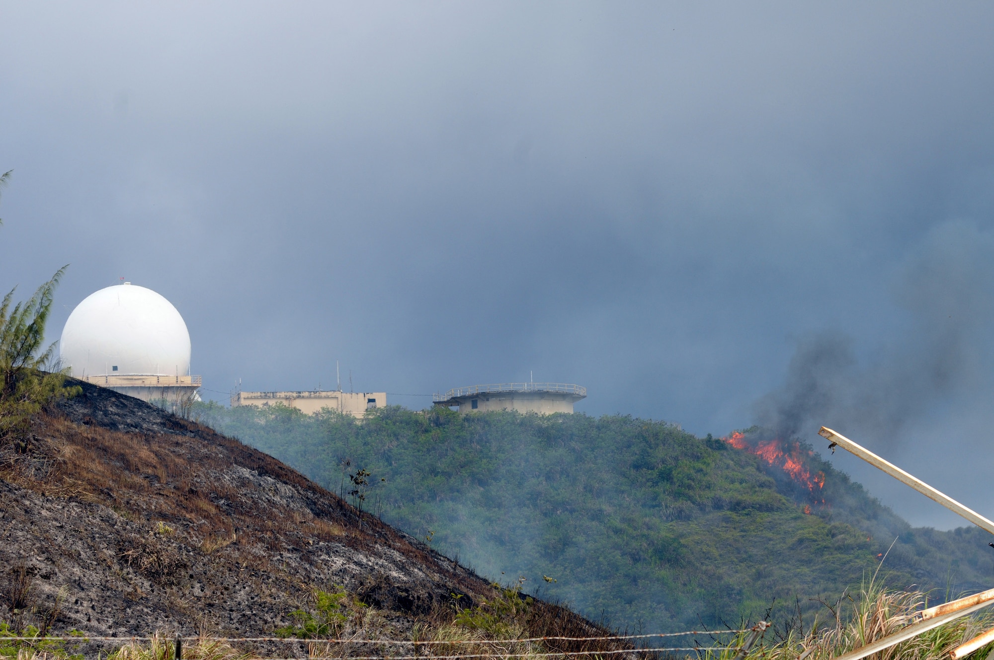 ANDERSEN AIR FORCE BASE, Guam - Fire climbs a ridge threatening a Federal Aviation Administration facility June 17.  Firefighters worked from 1 to 6 p.m. to contain and extinguish a wild fire that burned approximately 50 acres on Mt. Santa Rosa.  The fire threatened two Department of Defense sites valued at $30 million, a commercial site valued at $1.4 million and 27 houses.  A combined effort by the Guam Fire Department, Andersen AFB Fire Department, Navy Helicopter Sea Combat Squadron 25 aerial support, Navy Fire Department, 36th Civil Engineer Squadron, 554th RED HORSE Squadron totaling 68 people and 13 support vehicles contained the fire. (U.S. Air Force photo by Tech. Sgt. Michael Boquette)