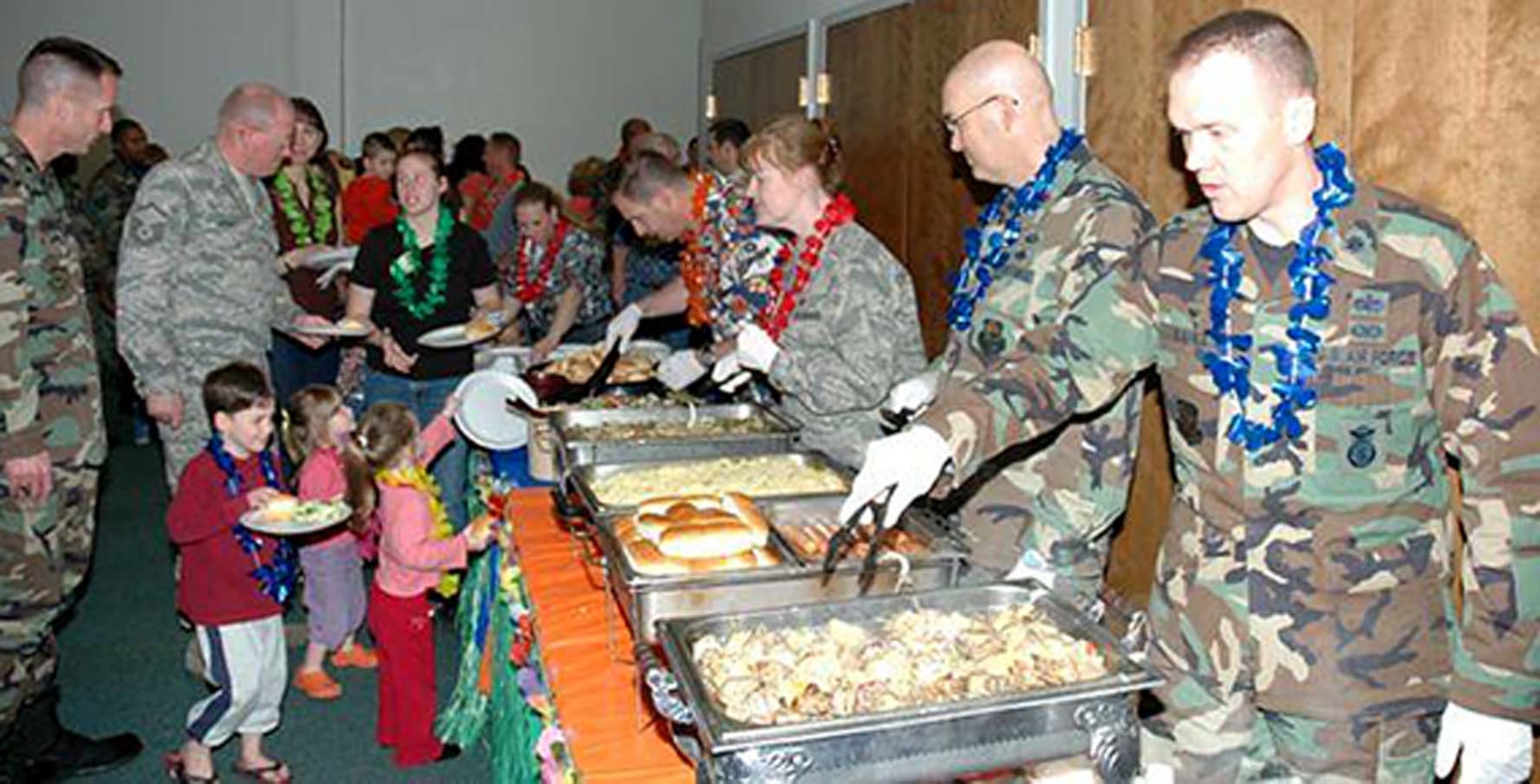 Families of spouses enjoy a previous deployed family dinner hosted by the chaplains office here.  This years nourishment is provided by Famous Dave's.  (Courtesy photo)