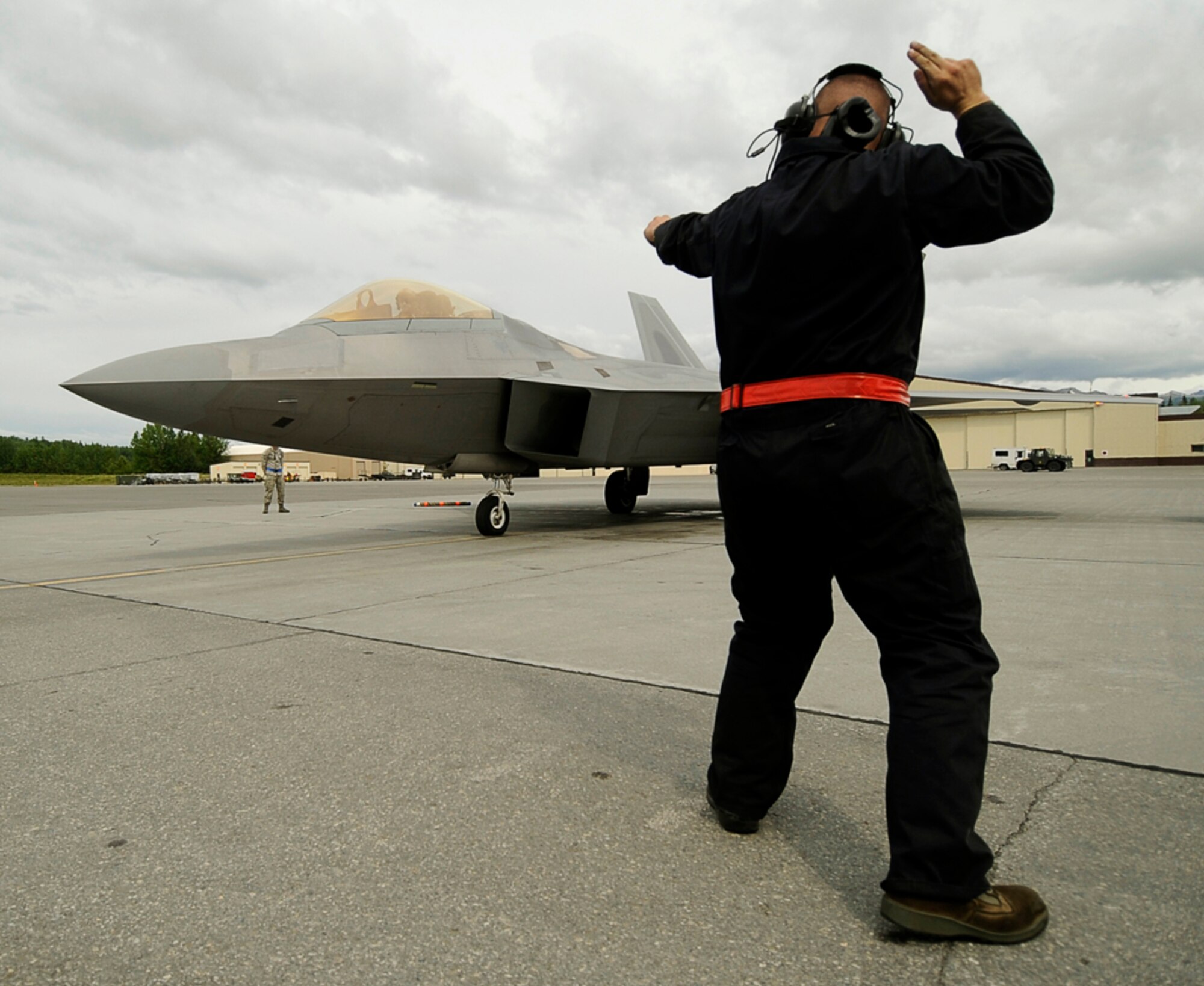 Airman 1st Class Holden Coladonato from the 90th Fighter Squadron, Elmendorf AFB, Alaska, prepares a F-22 Raptor for take off during exercise Northern Edge 2009, Elmendorf AFB, Alaska, June 17, 2009.  Northern Edge 2009 is Alaska's largest military training exercise.  It prepares joint forces to respond to crises throughout the Asia-Pacific region.  (Released/U.S. Air Force photo by TSgt Dennis J. Henry Jr.)