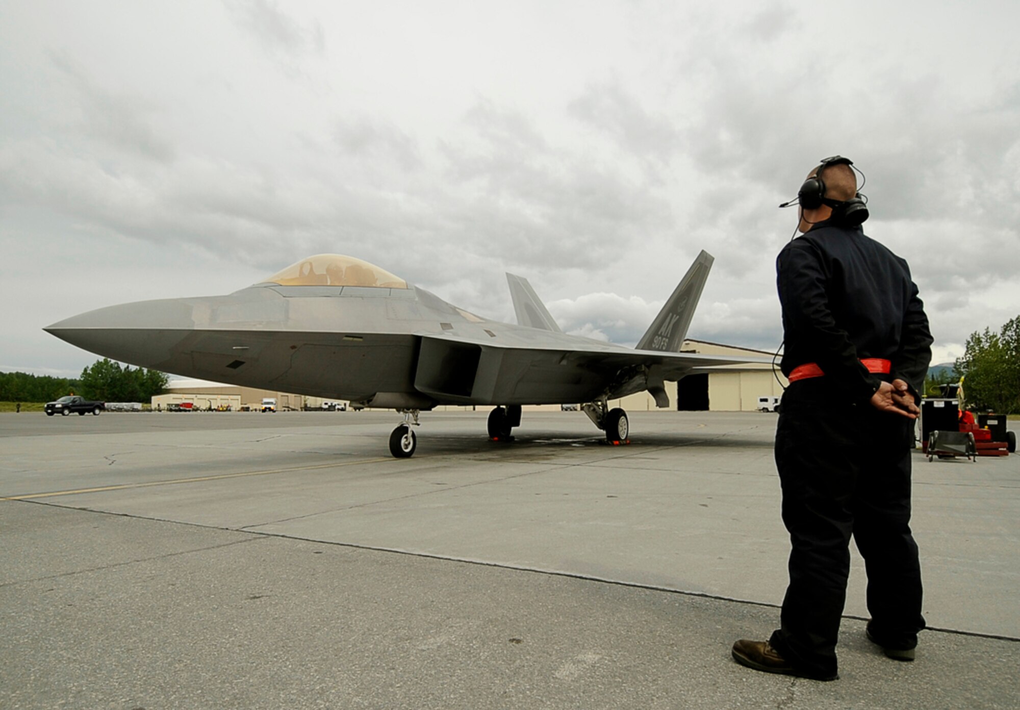 Airman 1st Class Holden Coladonato from the 90th Fighter Squadron, Elmendorf AFB, Alaska, prepares a F-22 Raptor for take off during exercise Northern Edge 2009, Elmendorf AFB, Alaska, June 17, 2009.  Northern Edge 2009 is Alaska's largest military training exercise.  It prepares joint forces to respond to crises throughout the Asia-Pacific region.  (Released/U.S. Air Force photo by TSgt Dennis J. Henry Jr.)