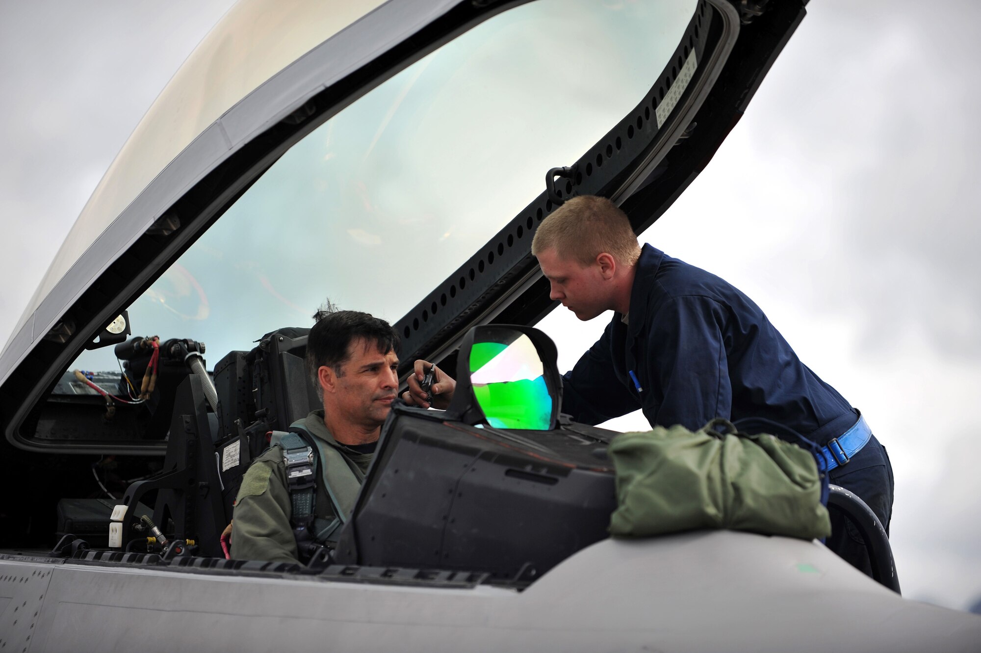 Airman 1st Class Shane Brewster straps Lt. Col. John Hillyer into his F-22 Raptor fighter aircraft June 17, 2009, during Northern Edge 09 held at Elmendorf Air Force Base, Alaska. Brewster is a member of the 525th Aircraft Maintenance Unit and Hillyer is the 477th Fighter Group commander at Elmendorf AFB. Northern Edge is Alaska's largest military training exercise that prepares joint forces to respond to crises throughout the Asia-Pacific region. (U.S. Air Force photo/Master Sgt. Shane A. Cuomo)
