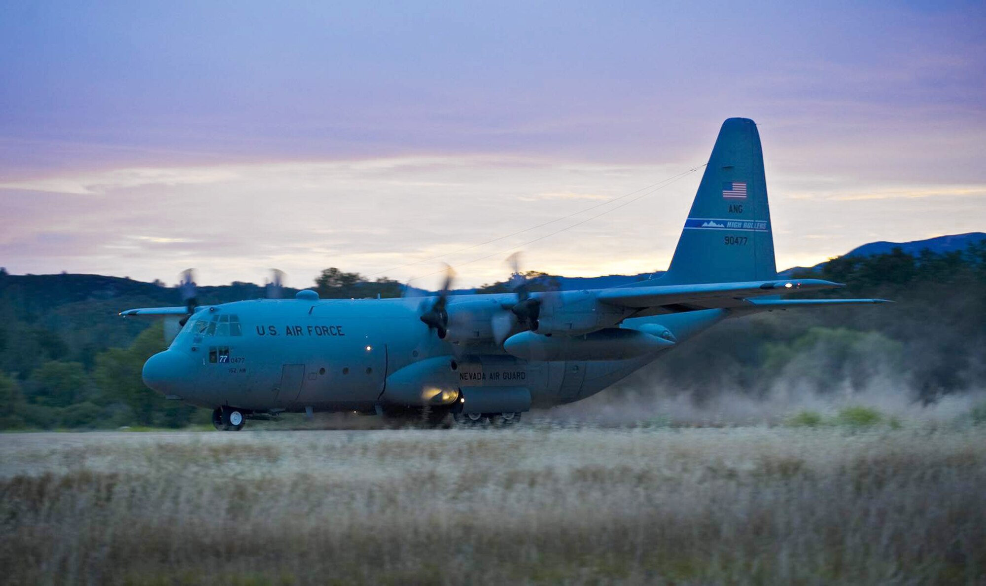 A C-130 Hercules takes off on a dirt landing strip on Schoonover Landing Zone at Fort Hunter-Ligget, Calif. during the Hydra Exercise 2009.  Hydra is a training exercise developed to provide a West Coast venue to train the 615 Contingency Response Wing's unique mission capabilities such as, command and control, aerial port, maintenance and air mobility liaison duties in a joint environment.  (U. S. Air Force photo/Master Sgt. Cecilio Ricardo)