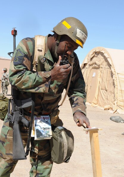 Master Sgt. Jimmy Green, 49th Medical Support Squadron, reports to his Unit Control Center after finding no sign of simulated contamination on the chemical stand outside his tent at the Civil Engineer Pit, June 16, at Holloman Air Force Base, N.M. Sergeant Green was part of a two-man post attack reconnaissance team during the Phase II exercise. (U.S. Air Force photo/Airman 1st Class Sondra Escutia)