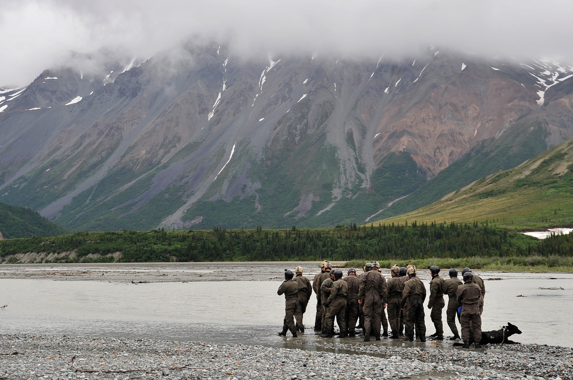 A group of Navy SEALs prepares to cross Phelan Creek during NORTHERN EDGE 2009, June 17. NE09 is a large scale exercise hosted in Alaska to improve command, control and communications between the Armed Services. The Northern Warfare Training Center and the SEALs worked together on river crossing techniques and rope handling. (U.S. Air Force photo/Staff Sgt. Christopher Boitz)