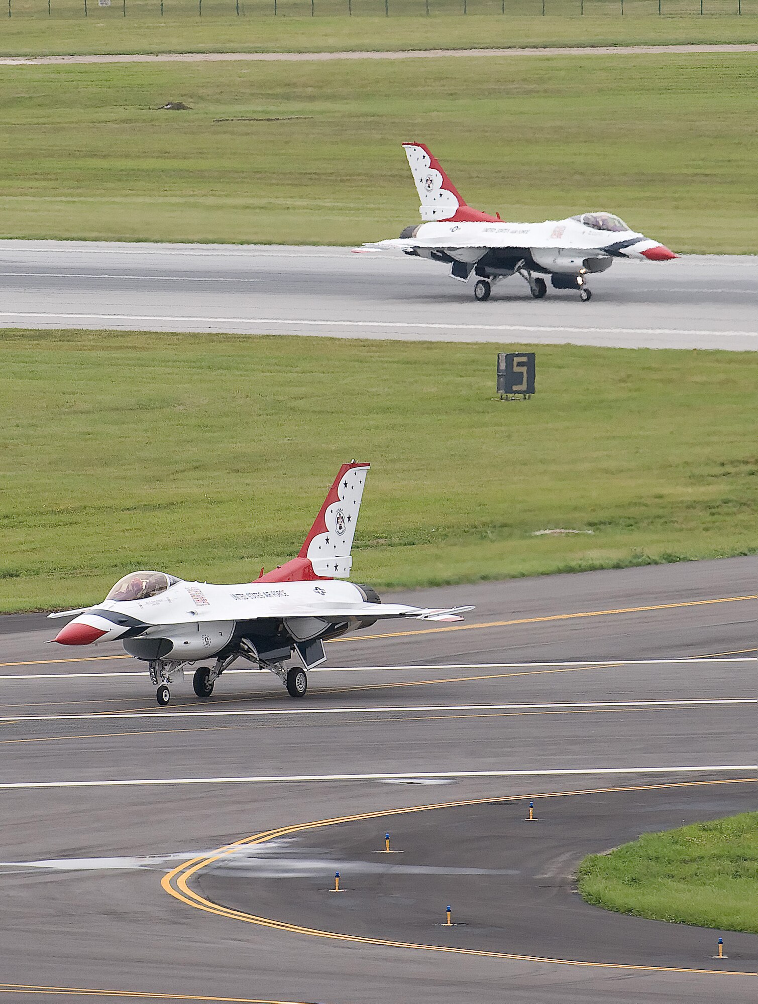 Two U.S. Air Force Thunderbirds F-16 Falcons taxi after landing at Dover Air Force Base, Del., June 18. The Thunderbirds will bring their high-flying stunts and aerial expertise to the Dover AFB Open House and Air Show June 20 and 21. (U.S. Air Force Photo/Jason Minto)