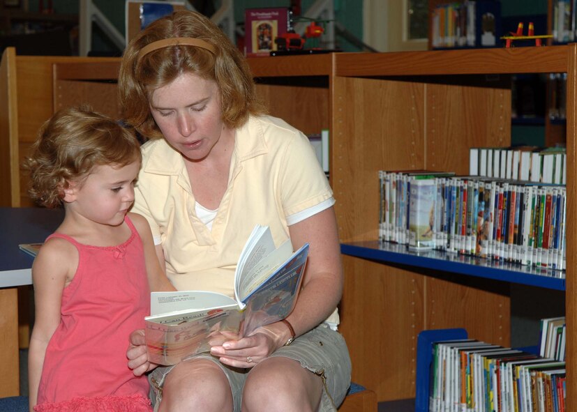 BARKSDALE AIR FORCE BASE, La. -- Stacy Jones and her daughter Abby read together at the Barksdale Base Library as part of the summer reading program. On average an elementary school student can lose approximately one-to-two-months worth of learned information over summer vacation. This number varies across age, grade level and subject matter and is due to out-of-school influences and a lack of learning opportunities throughout the summer. (U.S. Air Force photo by Senior Airman Joanna M. Kresge)
