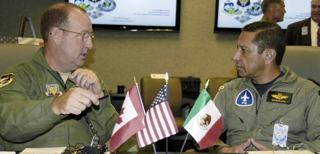 Maj. Gen. Hank Morrow (left), 1st Air Force commander, discusses homeland operations with Maj. Gen. Carlos Antonio Rodriguez Munguia, deputy director of operations for the Mexican air force.  (U.S. Air Force photo)