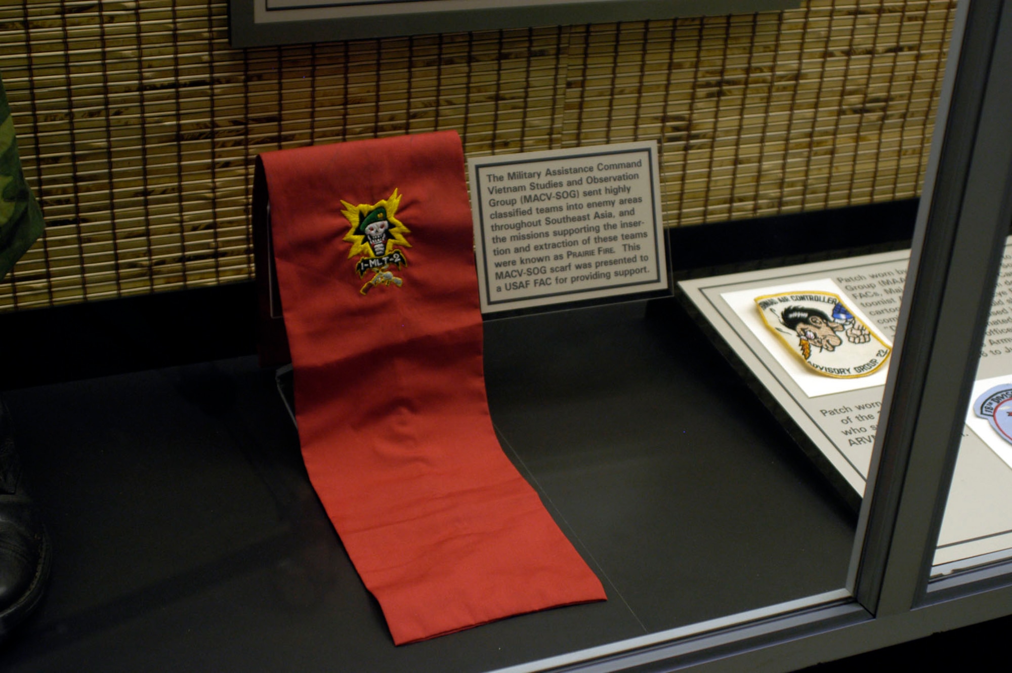 DAYTON, Ohio - The Military Assistance Command Vietnam Studies and Observation Group (MACV-SOG) sent highly classified teams into enemy areas throughout Southeast Asia, and the missions supporting the insertion and extraction of these teams were known as PRAIRIE FIRE. This MACV-SOG scarf was presented to a USAF FAC for providing support. The scarf is on display in the A Dangerous Business: Forward Air Control exhibit in the Southeast Asia War Gallery at the National Museum of the U.S. Air Force. (U.S. Air Force photo)