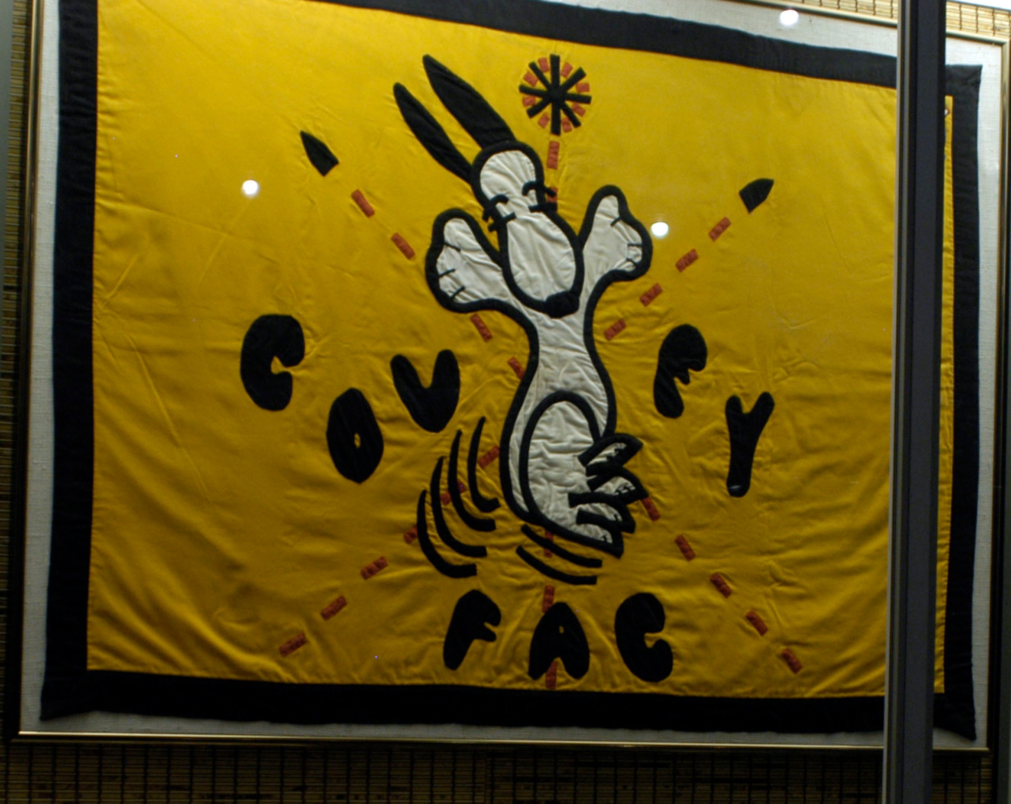 DAYTON, Ohio - Just as Airmen have done since World War I, the FACs in Southeast Asia brought a part of home with them by incorporating popular cartoon characters into nose art, uniform patches, and other military items. This unofficial flag was used by the FACs of the 20th TASS, who flew with the call sign Covey. Made by the wife of one of the Covey FAC’s, it has the popular character “Snoopy” from Charles Schulz’s comic strip Peanuts. The flag is on display in the A Dangerous Business: Forward Air Control exhibit in the Southeast Asia War Gallery at the National Museum of the U.S. Air Force. (U.S. Air Force photo)