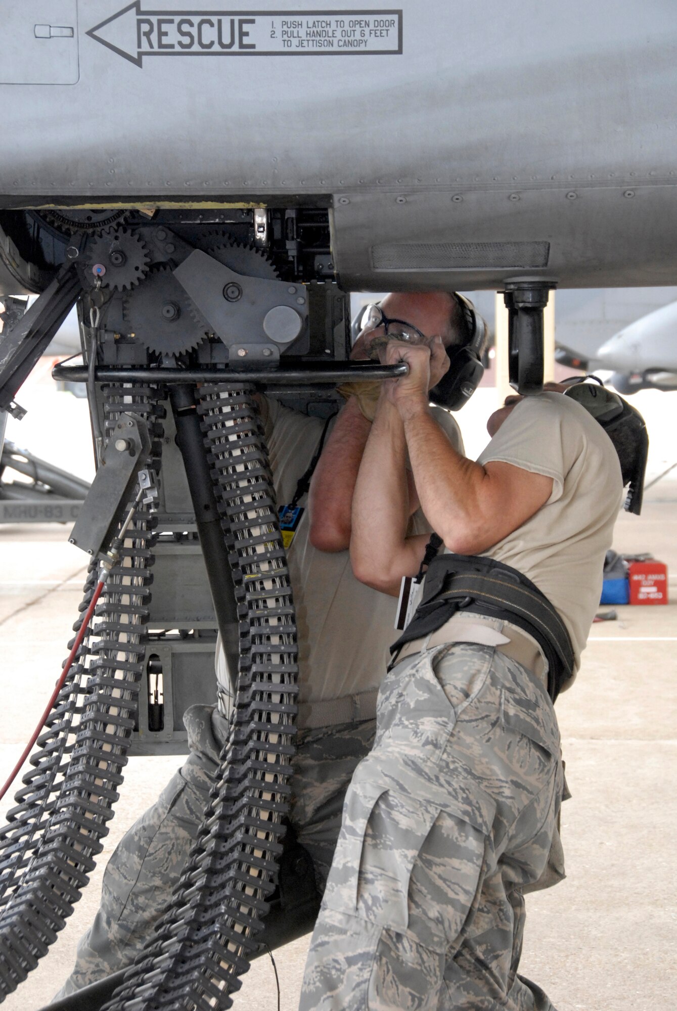Master Sgt. William Porterfield and Staff Sgt. Lincoln McCoy connect an ammunition-loading assembly to an A-10 Thunderbolt II during a weapons-load competition at Whiteman Air Force Base, Mo. The competition is designed to hone the loaders' skills in safely and quickly rearming an A-10 after a combat sortie. Sergeants Porterfield and McCoy are Air Force reservists in the 442nd Aircraft Maintenance Squadron, part of the 442nd Fighter Wing, based at Whiteman. (U.S. Air Force photo/Senior Airman Danielle Wolf)