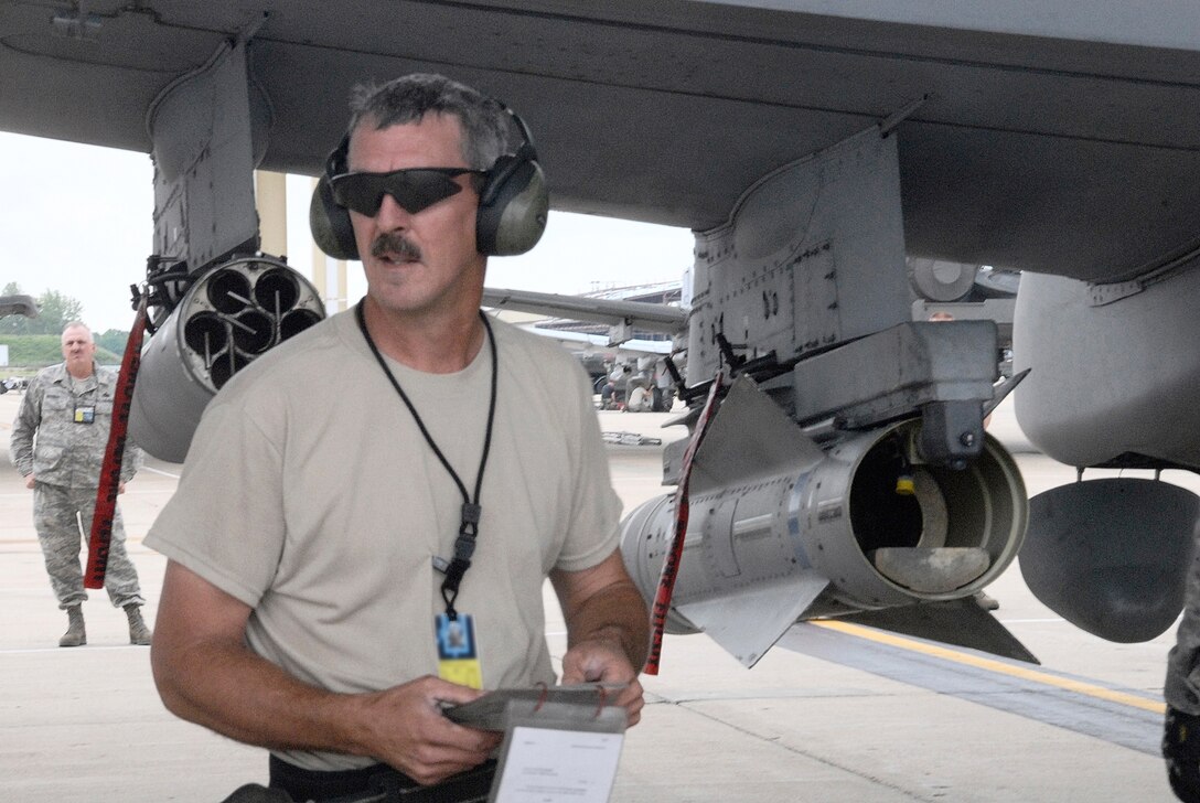 Master Sgt. William Porterfield, weapons-load crew chief, ensures his team's compliance with technical-order checklists during an A-10 Thunderbolt II weapons- load competition at Whiteman Air Force Base, Mo. The competition is designed to hone the loaders' skills in safely and quickly rearming an A-10 after a combat sortie. Sergeant Porterfield is an Air Force reservist in the 442nd Aircraft Maintenance Squadron, part of the 442nd Fighter Wing, based at Whiteman. (U.S. Air Force photo/Senior Airman Danielle Wolf)