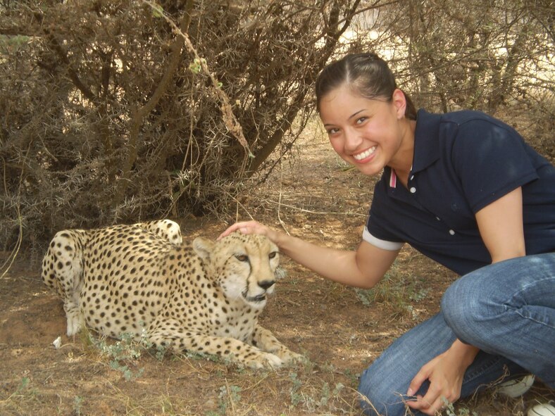 Senior Airman Krystal Rannals, 129th Maintenance Group, poses with a cheetah during a USO trip to a Cheetah Refuge in Djibouti.(Photo courtesy of Senior Airman Krystal Rannals)