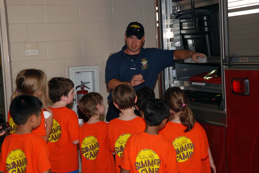 Beau Albert, Base Fire department. explains the items found on a fire truck to young members of The Sunshine House summer camp June 18.. Nearly 20 children from the Marietta-based school toured Dobbins ARB to learn about careers within the Air Force Reserves. (U.S. Air Force photo/Kennith Green)