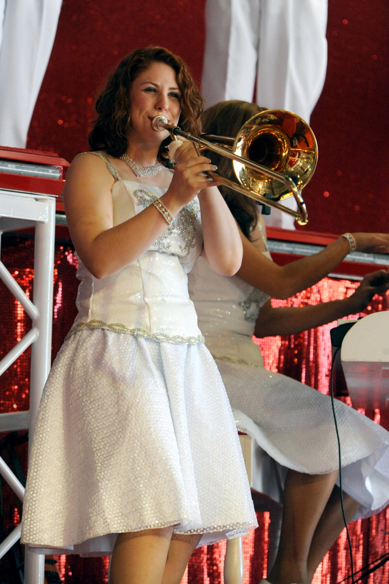 Senior Airman Victoria Howard, trombonist for
the 2009 Tops in Blue tour, plays before a crowd of during Hill Air Force Base's Open House during Air Force Week Salt Lake City, June 6.  Airman Howard is assigned to the 459th Aeromedical Evacuation Squadron at Andrews Air Force Base, MD. (U.S. Air Force Photo by Staff Sgt. Kyle Brasier)


