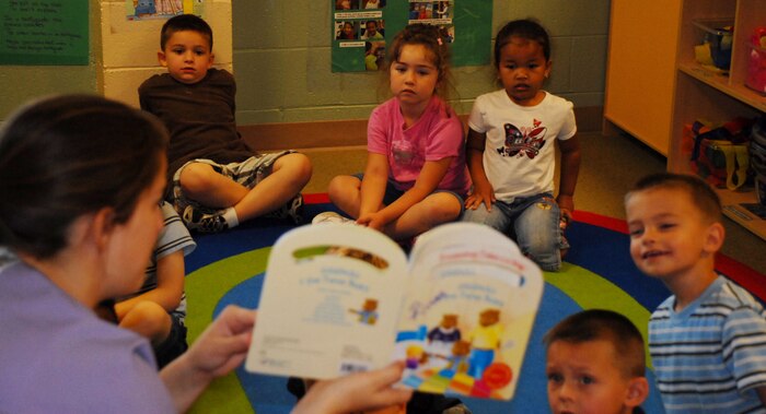 Sara Hock, a 9th FSS CDC teacher, reads to her class June 17 at the CDC. All classes, no matter the age, have a curriculum teachers follow to expedite the learning process.(Photo by Airman 1st Class Chuck Broadway)