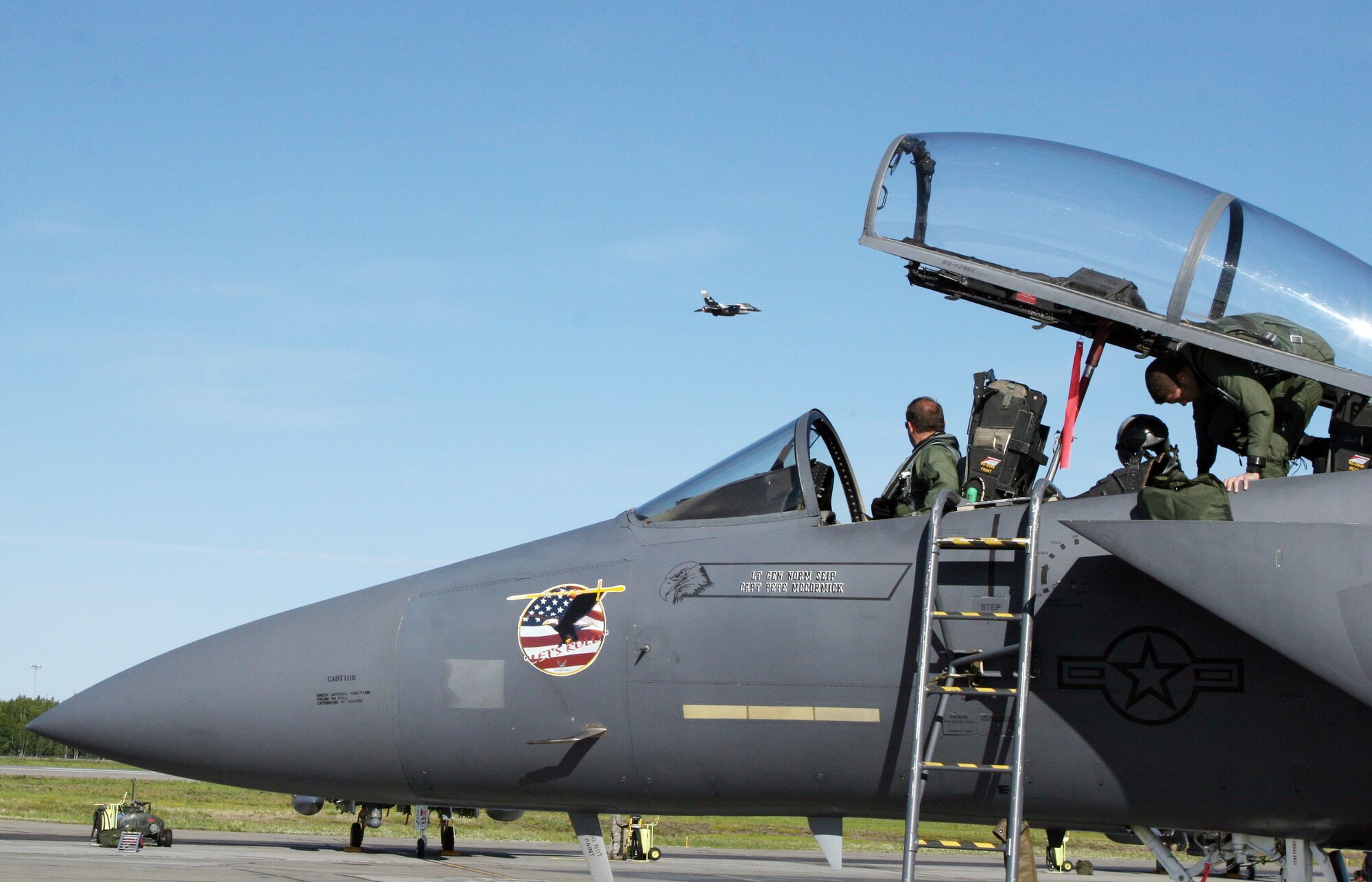 An F-15E Strike Eagle from Mountain Home Air Force Base, Idaho, prepares for takeoff at Eielson AFB, Alaska, June 16 as an F-16 Fighting Falcon passes by. The aircraft are participating in Exercise Northern Edge 2009. (U.S. Marine Corps photo/Staff Sgt. Andrew Miller)