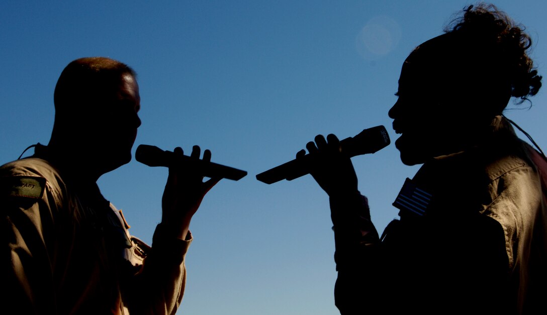 MSgts Ryan Carson and Regina Coonrod share a silhouetted duet during a performance for the dedication of the Air Force Memorial in Arlington, Va., on October 14, 2006.