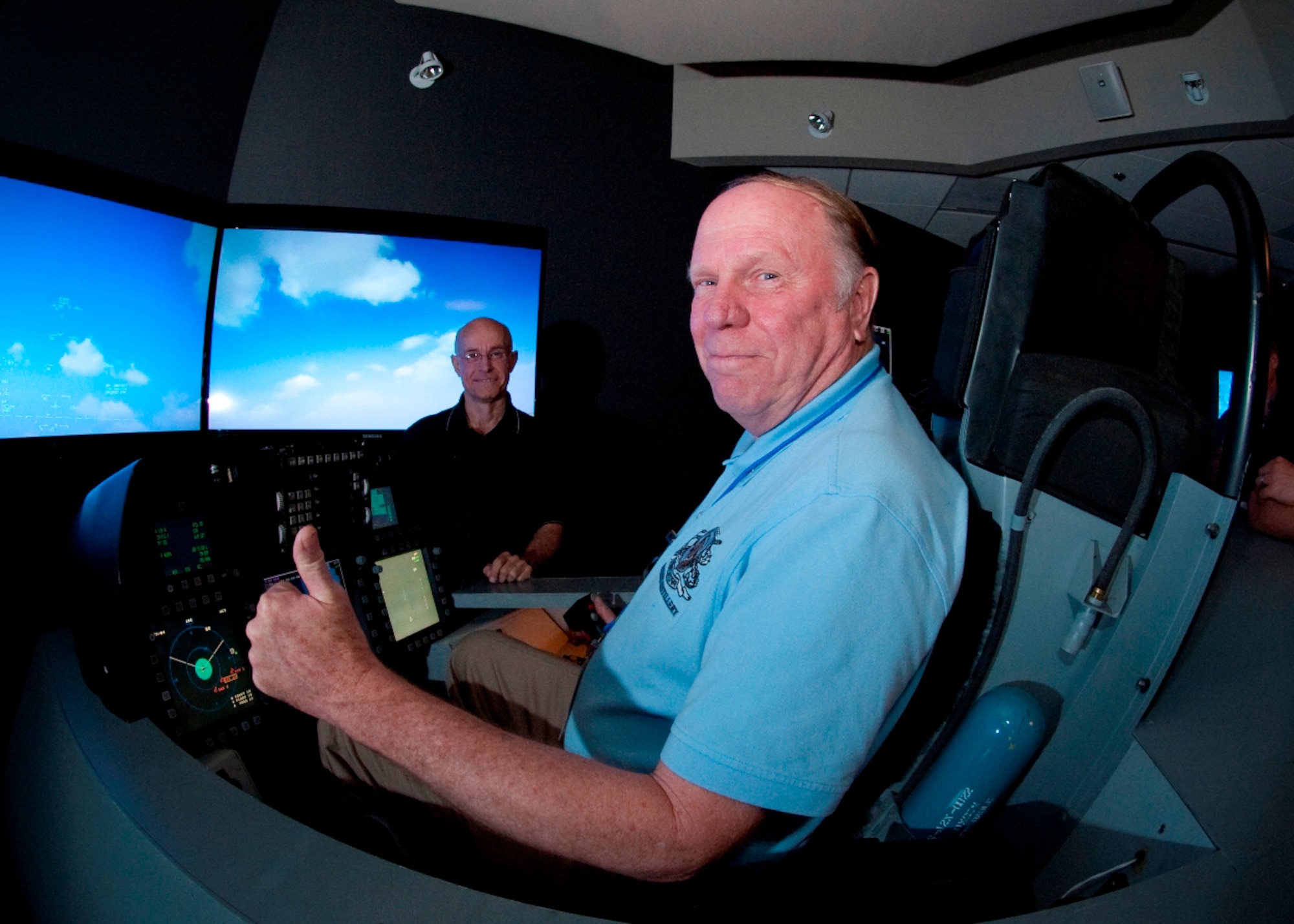 Community Relations Tour attendant Phil Pritchard, president of Pritchard’s Distillery, Inc., is seen here “flying” the F-22A Raptor in the Lockheed Martin Marietta, Ga., assembly facility’s F-22 cockpit simulator. (Photo courtesy of Lockheed Martin)