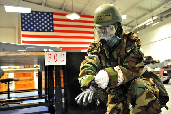 SHAW AIR FORCE BASE, S.C. -- Airman 1st Class Tyrone De Belen, 20th Equipment Maintenance Squadron, dons his chemical protective gloves during Team Shaw's operational readiness inspection, June 17. The ORI will evaluate the training and preparedness of Shaw Airmen for worldwide deployment. (U.S. Air Force photo/Senior Airman Kathrine McDowell) 

