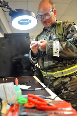 SHAW AIR FORCE BASE, S.C. -- Technical Sgt. Shawn Manning, 20th Component Maintenance Squadron, rebuilds a connector for a test bench cable during Team Shaw's operational readiness inspection, June 17. The ORI will evaluate the training and preparedness of Shaw Airmen for worldwide deployment. (U.S. Air Force photo/Senior Airman Kathrine McDowell) 
