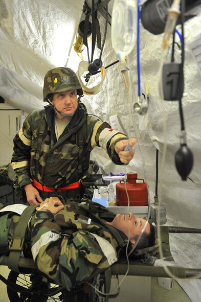 SHAW AIR FORCE BASE, S.C. -- Master Sgt. James Eidson, 20th Medical Operations Squadron primary care NCOIC, checks on Master Sgt. Jeffrey Fricke, 20th Force Support Squadron product manager, during Team Shaw's operational readiness inspection, June 17. Fricke's simulated ailment was a heart attack. The ORI will evaluate the training and preparedness of Shaw's airmen for homeland attack and worldwide deployment. (U.S. Air Force photo/Senior Airman Kathrine McDowell)
