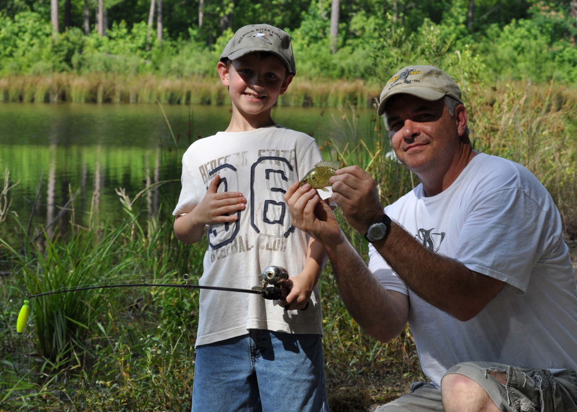 Grant Steele, 8, and his father Master Sgt. Greg Steele, 47th Fighter Squadron, visual information technician, show off Grant’s first “catch of the day” at Harmon Lake on the East Reservation of Barksdale Air Force Base, La., June 13, 2009. The family took in an afternoon of fishing on several of the lakes and ponds Barksdale has to offer up for the sport as well as camping on the East Reservation. Sergeant Steele is an Air Reserve Technician with the 47th FS. (Courtesy photo)