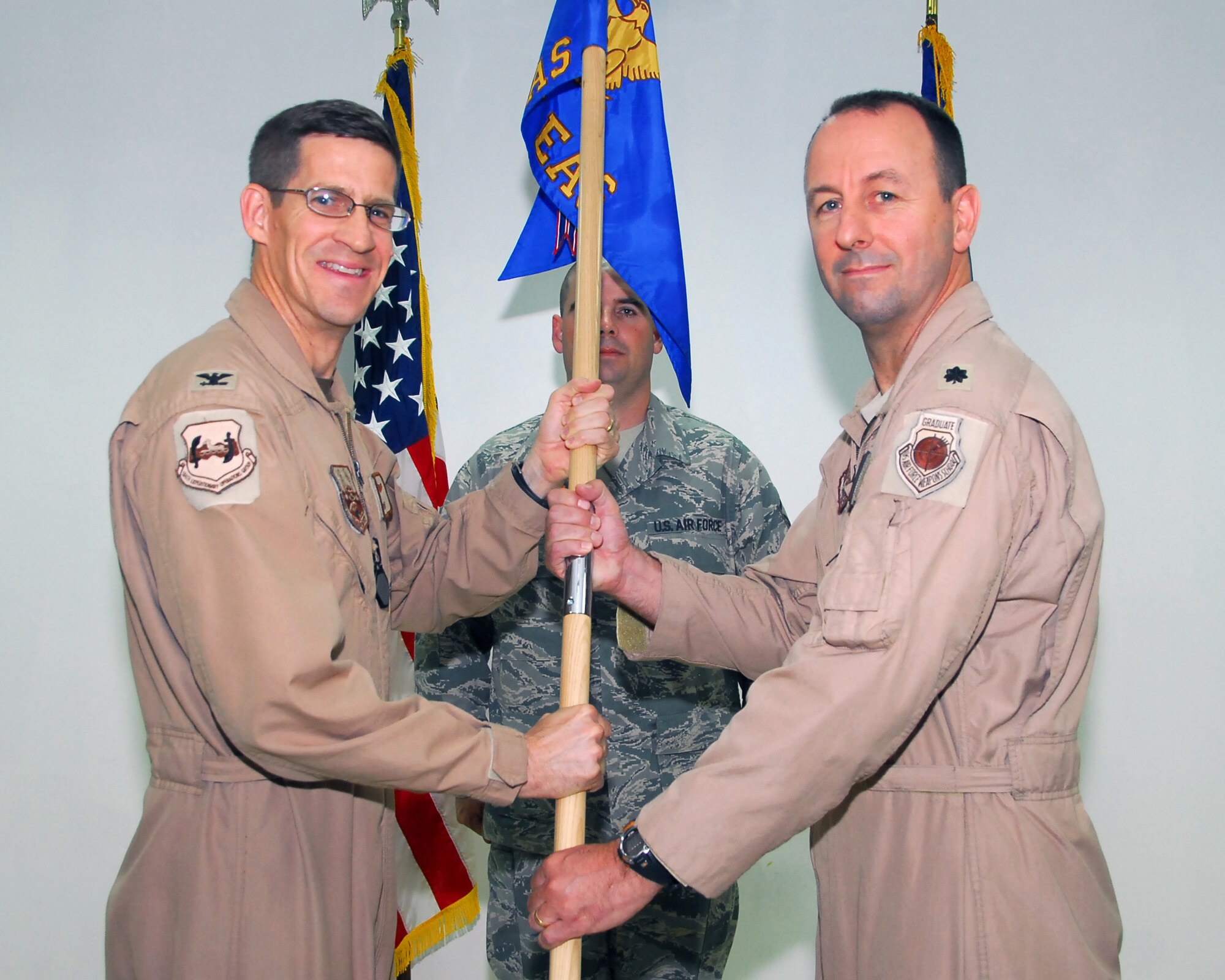 SOUTHWEST ASIA -- Lt. Col. Ben Akins recieves command of the 737th Expeditionary Airlift Squadron from Col. David Miller, 386th Expeditionary Operations Group commander, at an air base in Southwest Asia, June 17. Colonel Akins is deployed from Dyess Air Force Base, Texas.  (U.S. Air Force photo/Senior Airman Courtney Richardson)