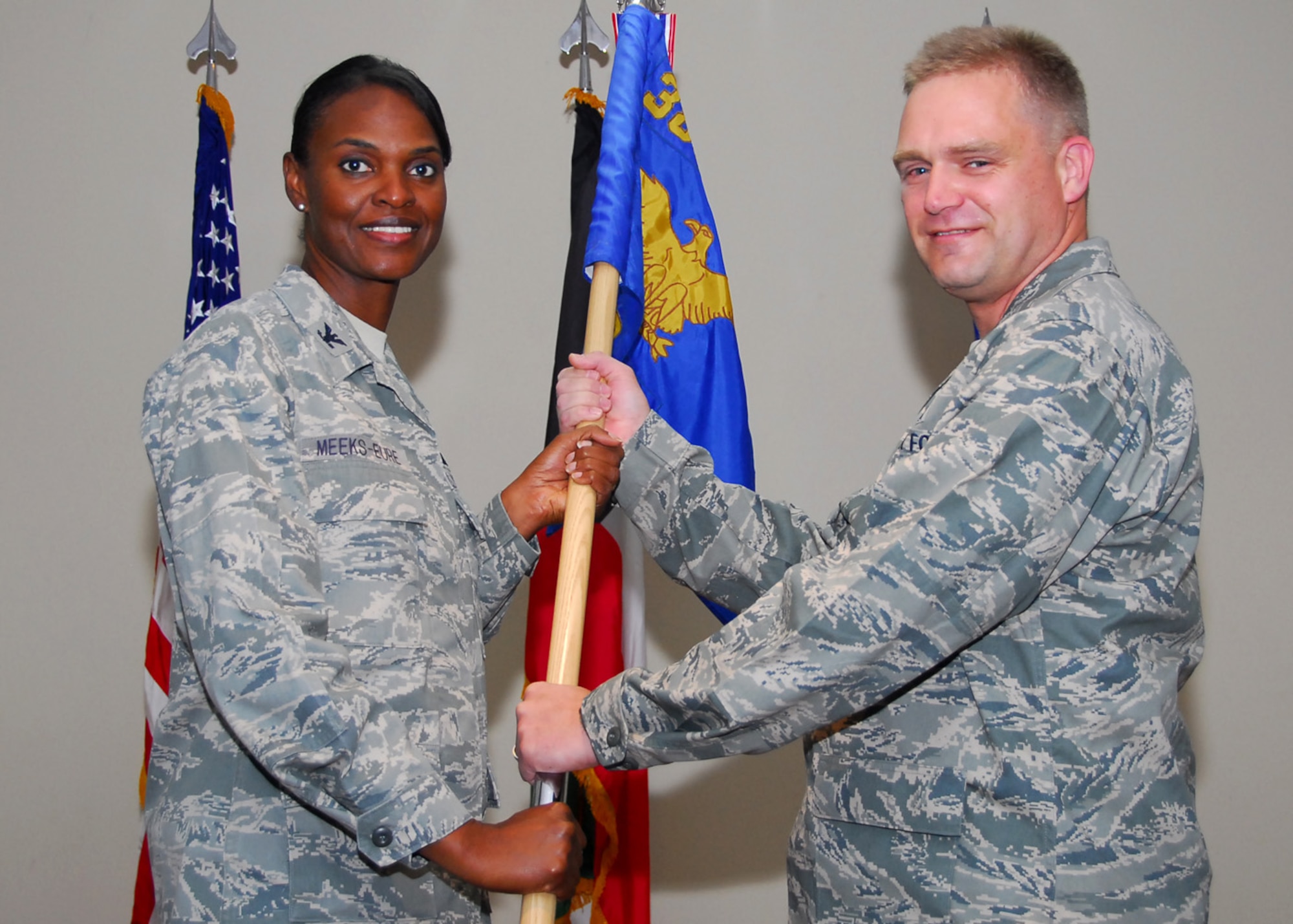 SOUTHWEST ASIA -- Lt. Col. John O'Connor receives command of the 386th Expeditionary Security Forces Squadron from Col. Marcia Meeks-Eure, 386th Expeditionary Mission Support Group commander, at an air base in Southwest Asia, June 18. Colonel O'Connor is deployed from U.S. European Command, Stuttgart, Germany. (U.S. Air Force photo/Senior Airman Courtney Richardson)