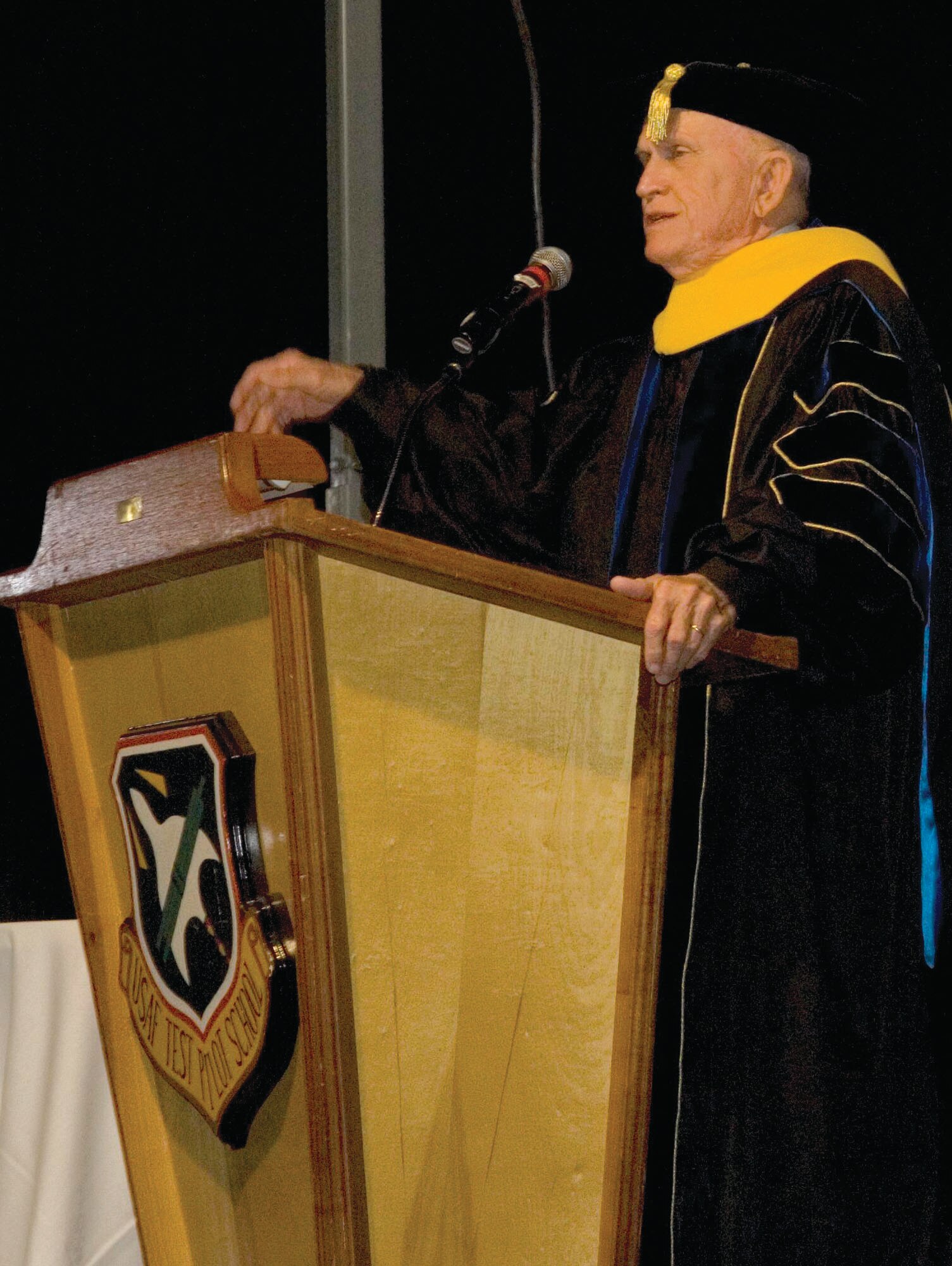 Retired Col. Frank Borman speaks to students, faculty, family and friends at the USAF Test Pilot School graduation Saturday at Edwards Air Force Base, Ala. Colonel Borman was honored by Lt. Gen. Allen G. Peck, the Air University commander, with an honorary doctor of science degree for his contributions to science and space exploration. Colonel Borman was selected for astronaut training in 1962 and led Apollo 8 on the first-ever orbit around the moon in 1968. (U.S. Air Force photo)