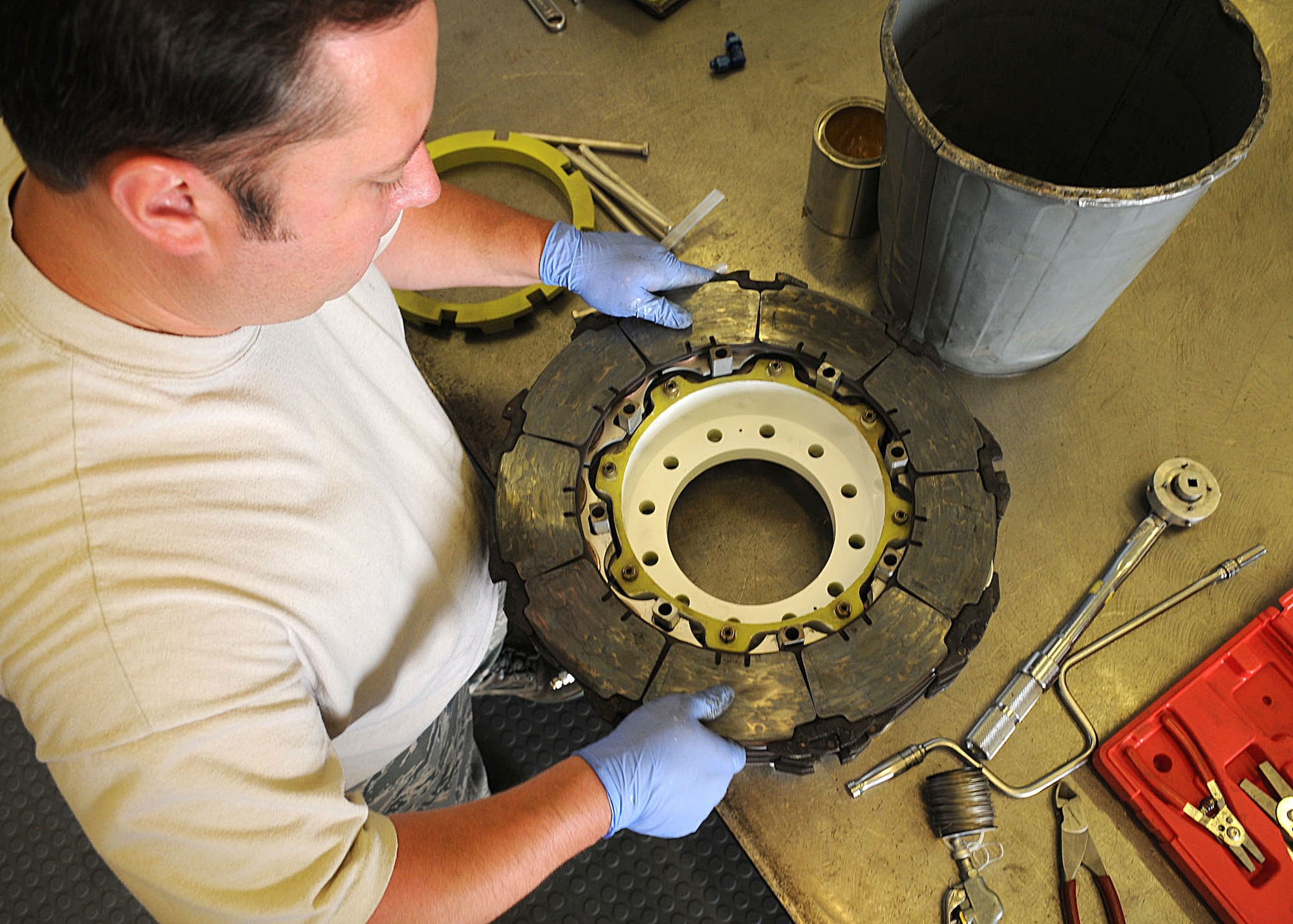 Staff Sgt. Ernest Kretschmar, 100th Maintenance Squadron hydraulics craftsman, places one of five rotors onto the assembly during an aircraft brake rebuild June 15, 2009, at RAF Mildenhall, England. The bulk of hydraulic back shops work is brake assembly rebuilds for the KC-135 Stratotanker and C-130 Hercules. They also perform inspections and maintenance on hydraulic-related items. (U.S. Air Force photo by Staff Sgt. Jerry Fleshman)