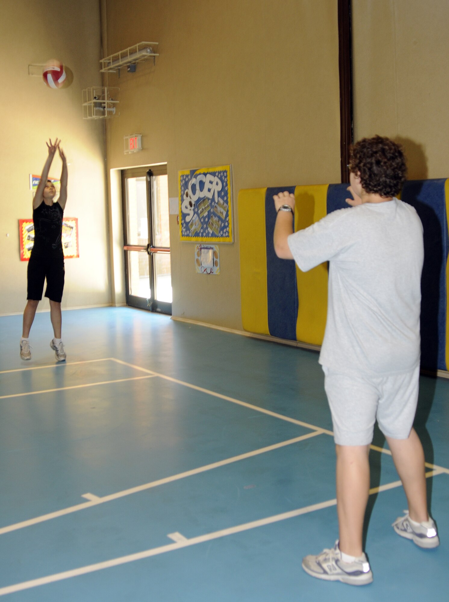 Katie and Ben Kaya, children of Elizabeth Kaya, 39th Communications Squadron, practice different volleyball techniques used during an actual game at the Youth Program’s volleyball camp Tuesday, June 16, 2009 at Incirlik Air Base, Turkey. The camp, which runs the entire week, is just one on a list of several camps and recreation trips available for children during their summer. Call YP at 676-6670 for more information about activities.  (U.S. Air Force photo/Airman 1st Class Amber Russell)