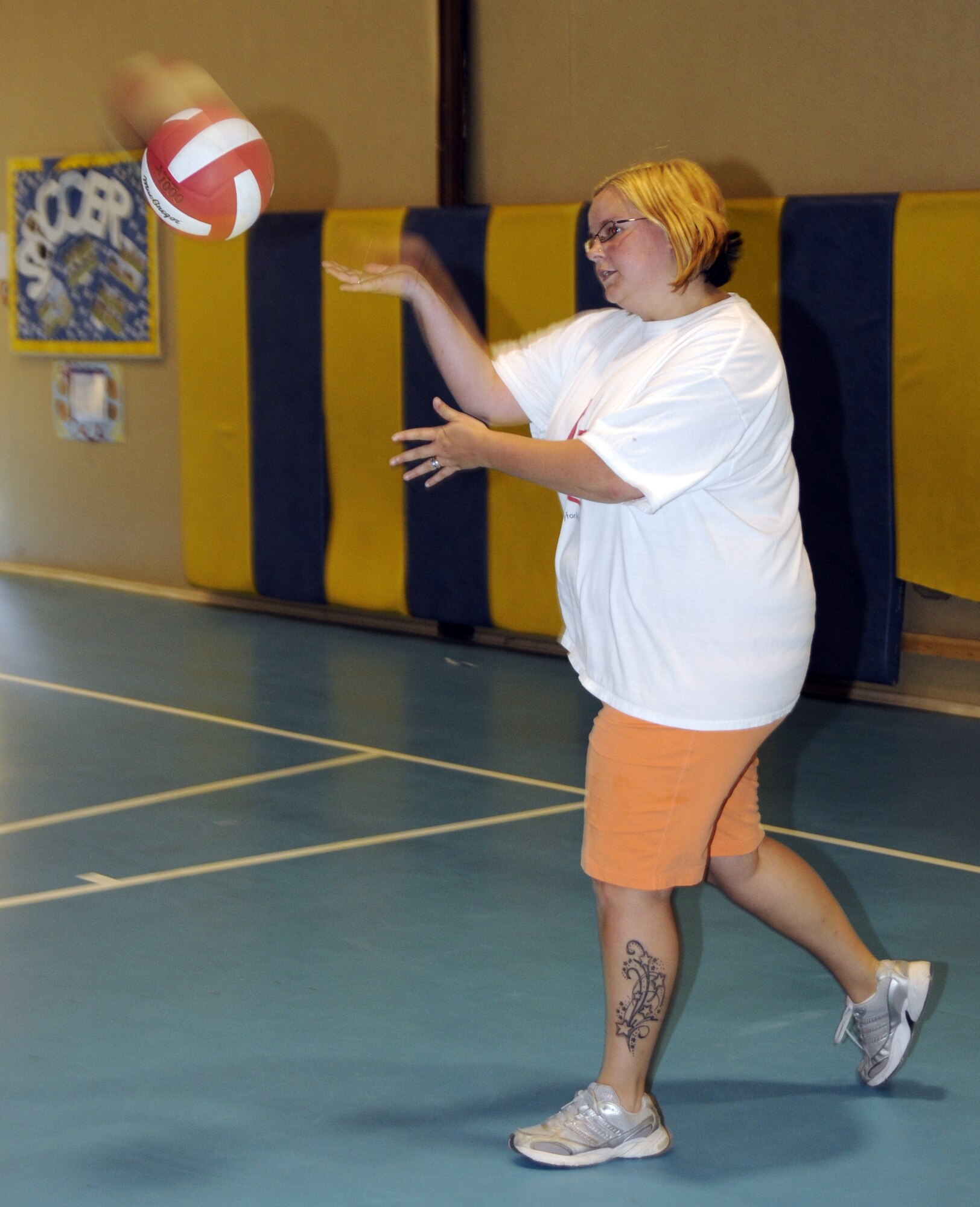 Stayce Osbourne, 39th Air Base Wing Youth Programs recreation assistant, demonstrates an under-hand serve to the youth at the YP volleyball camp Tuesday, June 16, 2009 at Incirlik Air Base, Turkey. The camp, which runs the entire week, is just one on a list of several camps and recreation trips available for children during their summer. Call YP at 676-6670 for more information about activities.  (U.S. Air Force photo/Airman 1st Class Amber Russell)