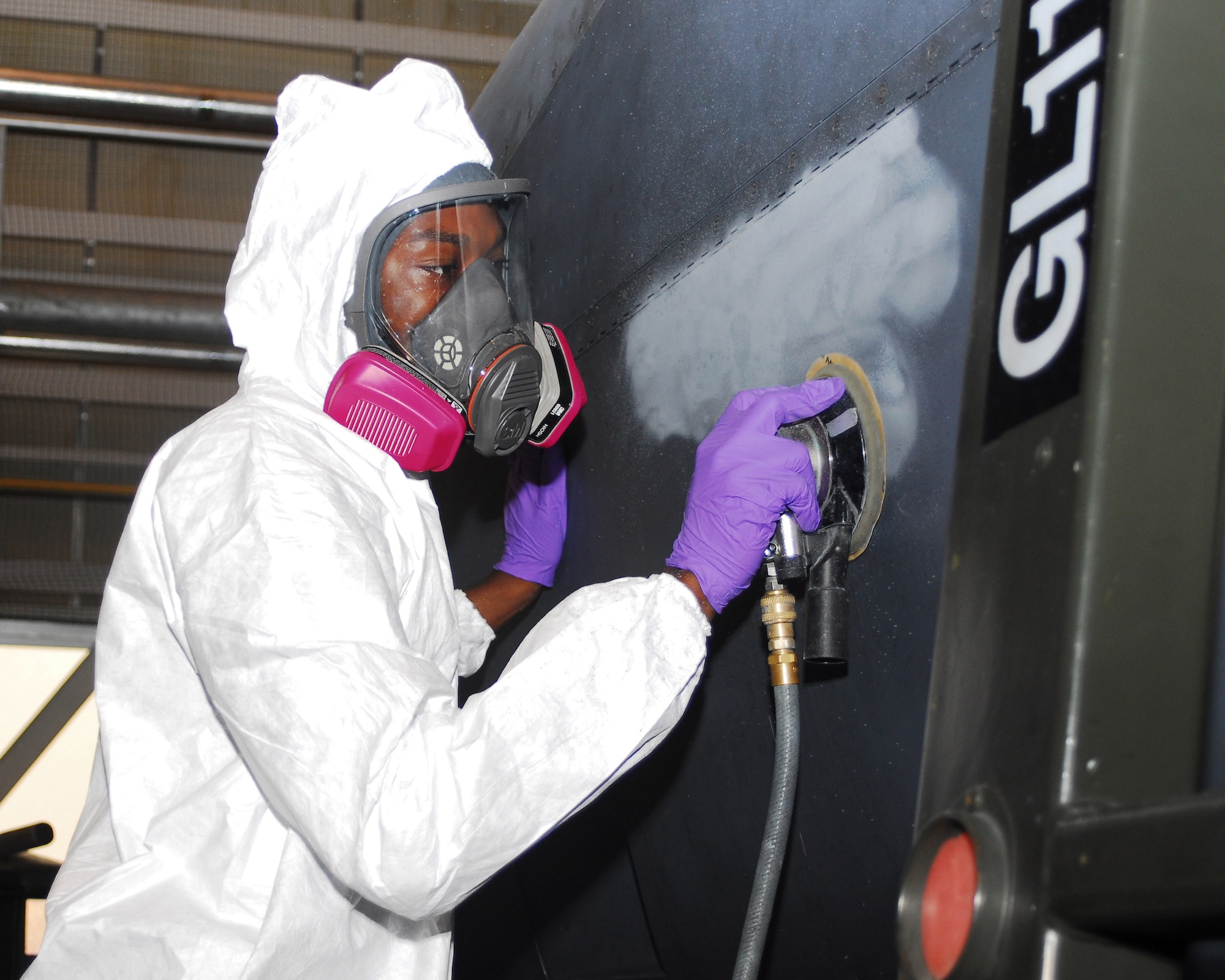 YOKOTA AIR BASE, Japan -- Airman 1st Class Christopher Fowler, 374th Maintenance Squadron fabrication flight refurbishing section, sands a C-130 engine before applying a fresh coat of paint June 18. The engine will be reinstalled after the refurbishing process is complete, thus making the aircraft mission ready. (U.S. Air Force photo/Airman Sean Martin)