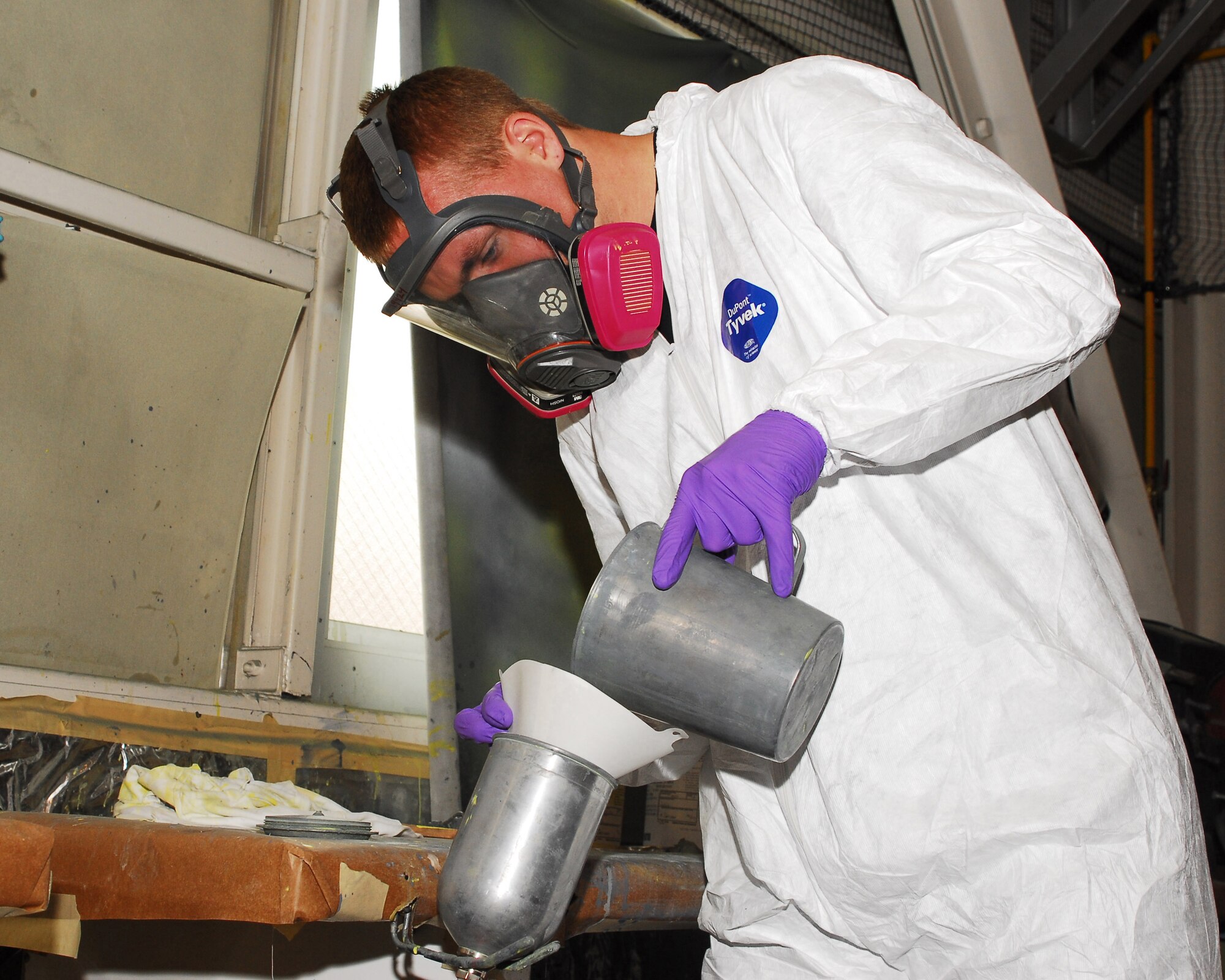 YOKOTA AIR BASE, Japan -- Airman 1st Class Christopher Patton, 374th Maintenance Squadron fabrication flight refurbishing section, adds grey paint to a high-pressure, low-volume gun used to paint a C-130 aircraft engine June 18. The engine will be reinstalled once the paint is dry, thus making the aircraft mission ready. (U.S. Air Force photo/Airman Sean Martin)