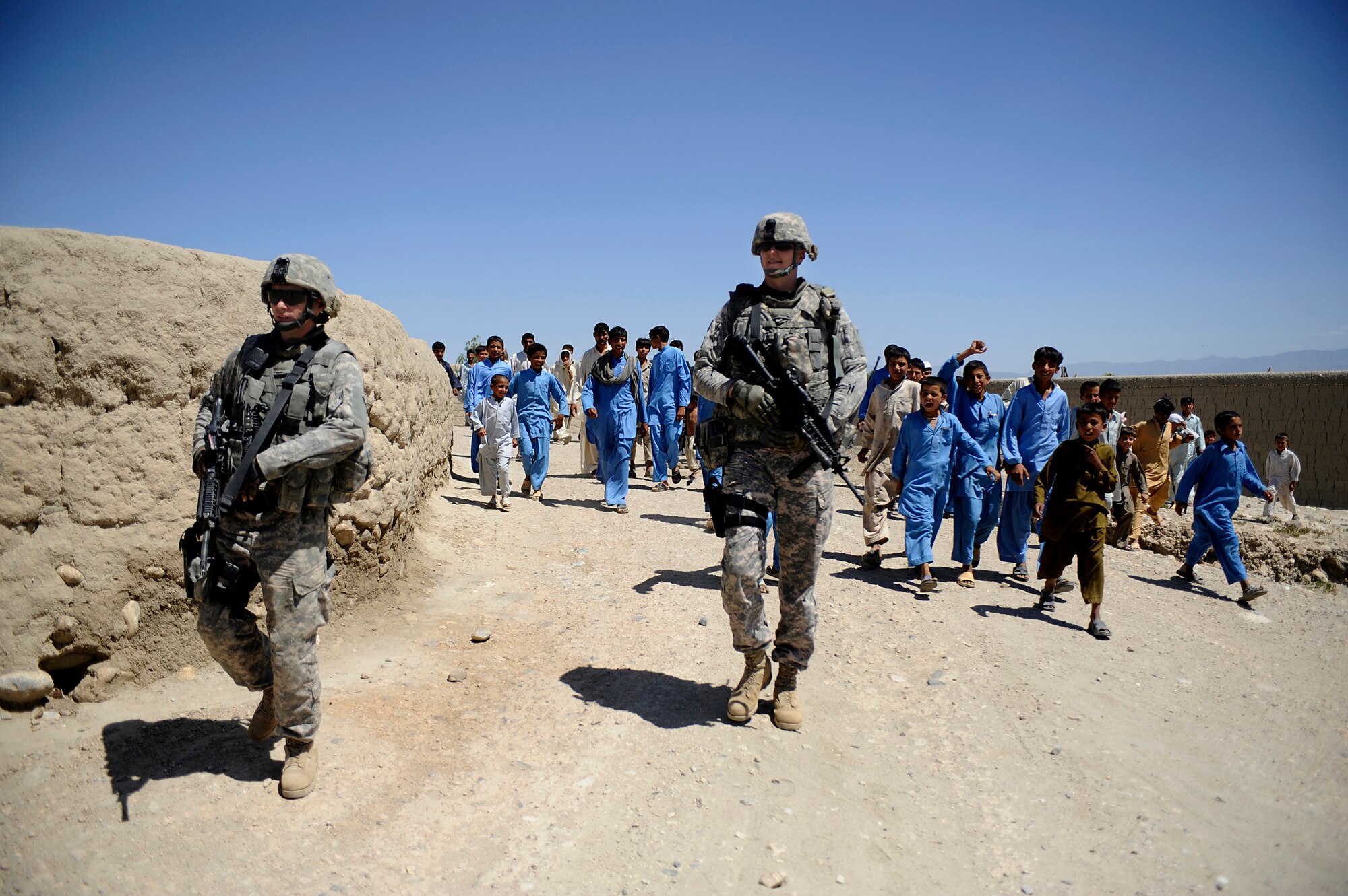 Staff Sgts. Daniel Salcedo (left) and Richard Robison, deployed from the Missouri Air National Guard, conduct a dismounted security check while the Nangarhar Agri-Business Development Team conduct quality assessment checks of a Rodat karize in Afghanistan May 28, 2009. The Nangarhar ADT is responsible for developing projects which will improve the agricultural production of the rural farming communities in the province. The team supports the construction of wells, karizes, veterinary clinics and reforestation projects. Both Airmen are deployed from the 139th Security Forces Flight, 139th Airlift Wing, Missouri Air National Guard. (U.S. Air Force photo by Staff Sgt. Shawn Weismiller)