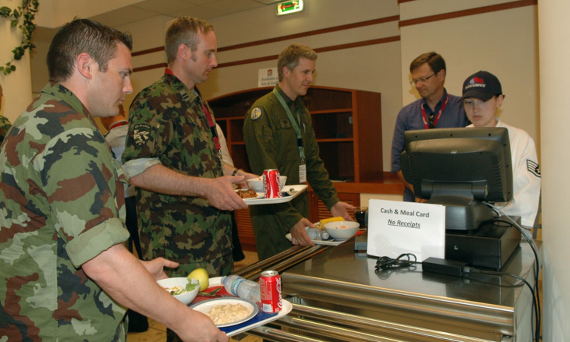Delegates representing such places as Ireland, Egypt and Mongolia, eat lunch at the Buon Appetito Dining Facility June 11, 2009, as part of Vienna Document 1999. The purpose of VDOC99 is to build mutual trust and understanding among the participating states through data exchanges and on-site inspections and is designed to increase transparency, thereby promoting cooperation, reducing misunderstandings and restoring/reinforcing stability during times of international conflict. (U.S. Air Force photo/Staff Sgt. Mercedes Crossland)