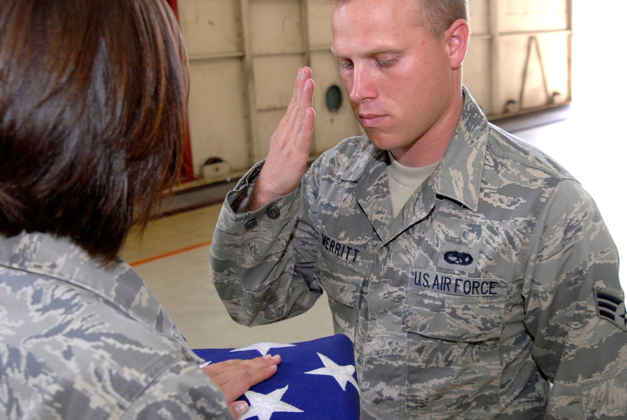 Senior Airman Jeremy Merritt, 8th Maintenance Squadron, salutes the American Flag as part of a flag folding ceremony while participating in Honor Guard practice at Kunsan Air Base, Republic of Korea, June 3. Kunsan's Honor Guard performs ceremonies ranging from change of command ceremonies to retirements. (U.S. Air Force Photo by SSgt Jason Colbert)





