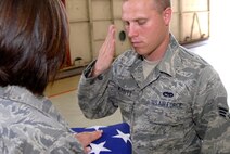 Senior Airman Jeremy Merritt, 8th Maintenance Squadron, salutes the American Flag as part of a flag folding ceremony while participating in Honor Guard practice at Kunsan Air Base, Republic of Korea, June 3. Kunsan's Honor Guard performs ceremonies ranging from change of command ceremonies to retirements. (U.S. Air Force Photo by SSgt Jason Colbert)





