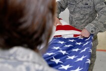 Staff Sgt Amanda Hibbler, 8th Fighter Wing Judge Advocates Office, holds the American Flag as Senior Airman Jeremy Merritt, 8th Maintenance Squadron, folds it  during a flag folding ceremony while participating in Honor Guard practice at Kunsan Air Base, Republic of Korea, June 3. Kunsan's Honor Guard performs ceremonies ranging from change of command ceremonies to retirements. (U.S. Air Force Photo by SSgt Jason Colbert)




