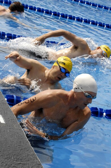 Cold Steel Triathlon participants kick off the wall during the 400 meter swim portion of the event June 13, at Osan Air Base, Republic of Korea. This is the second annual Cold Steel Triathlon hosted by the 3rd Battlefield Coordination Detachment - Korea (BCD-K).  More than 65 U.S., Korean, military and civilian contestants from across the peninsula competed in this event in order to test their physical and mental endurance. The triathlon consisted of a 400 meter swim, 12.4 miles bike race and 5k run. (U.S. Air Force photo/Senior Airman Stephenie Wade)
