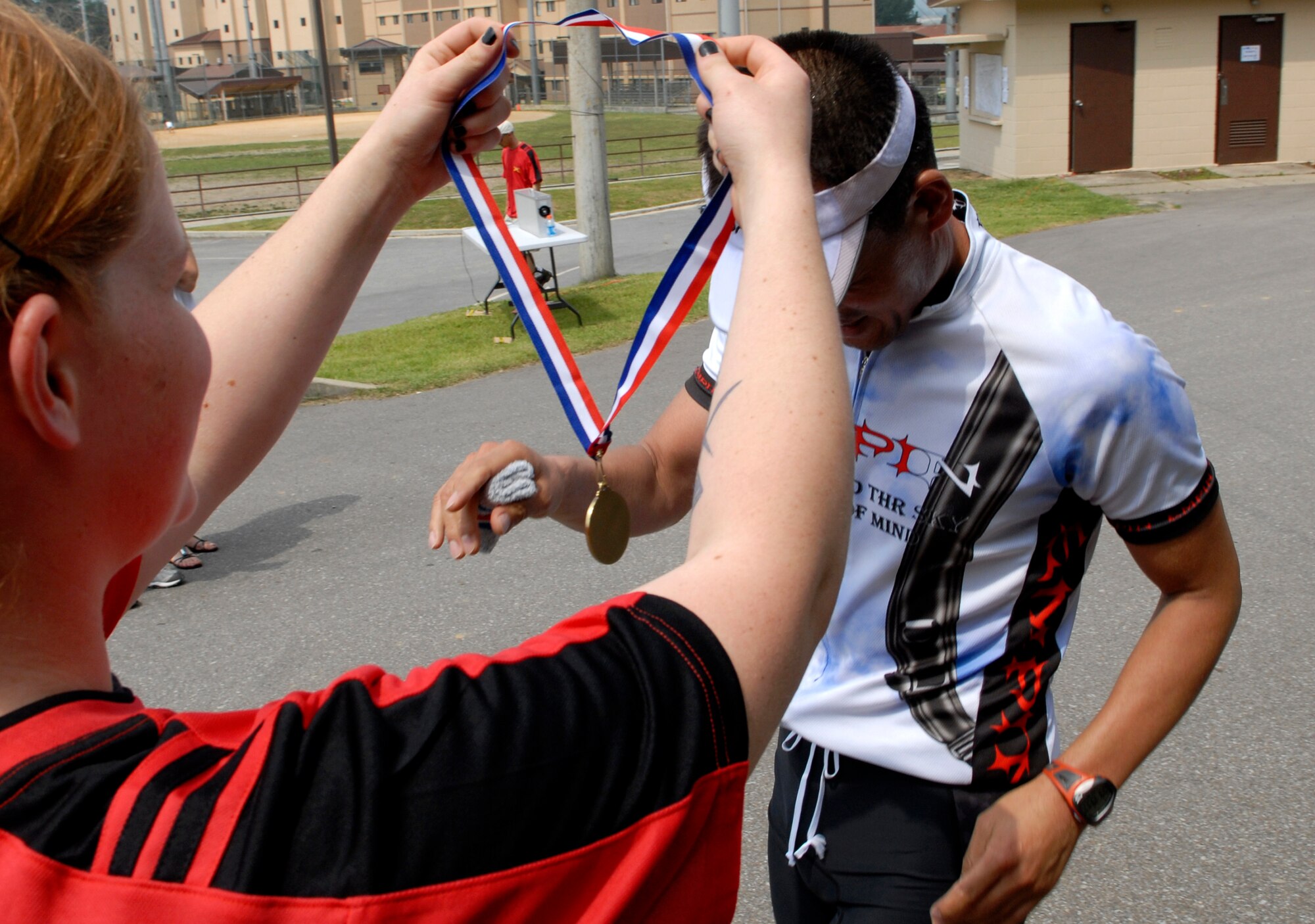 Medals were given to every Cold Steel Triathlon participant as they crossed the finish line June 13, at Osan Air Base, Republic of Korea. This is the second annual Cold Steel Triathlon hosted by the 3rd Battlefield Coordination Detachment - Korea (BCD-K).  More than 65 U.S., Korean, military and civilian contestants from across the peninsula competed in this event in order to test their physical and mental endurance. The triathlon consisted of a 400 meter swim, 12.4 miles bike race and 5k run. (U.S. Air Force photo/Staff Sgt Brian Ferguson)