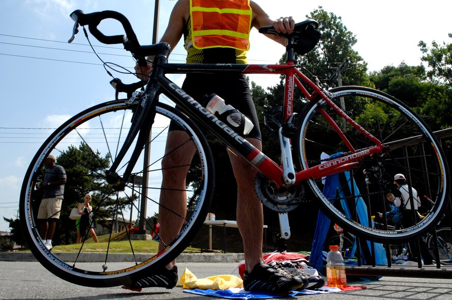 A Cold Steel Triathlon participant transitions from the 400 meter swim portion of the event to the bike portion June 13, at Osan Air Base, Republic of Korea. This is the second annual Cold Steel Triathlon hosted by the 3rd Battlefield Coordination Detachment - Korea (BCD-K).  More than 65 U.S., Korean, military and civilian contestants from across the peninsula competed in this event in order to test their physical and mental endurance. The triathlon consisted of a 400 meter swim, 12.4 miles bike race and 5k run. (U.S. Air Force photo/Staff Sgt Brian Ferguson)