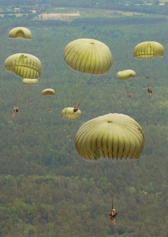 U.S. Army soldiers fill the sky and float toward the Sicily Drop Zone on Fort Bragg, N.C., during an air operation, June 6, 2009. The soldiers are assigned to Headquarters, Headquarters Company, U.S. Army Civil Affairs and Psychological Operations Command, Airborne.