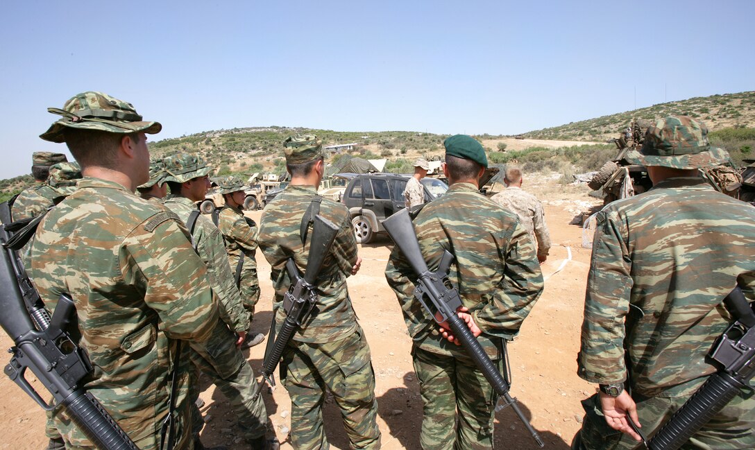 Greek Marines watch a demonstration of a vehicle search given by U.S. Marines at Melissatika training area outside Volos, Greece, June 11, 2009. The U.S. Marines are assigned to the 22nd Marine Expeditionary Unit, Battalion Landing Team, 3rd Battalion, 2nd Marine Regiment, which is in Greece for 12 days of training.