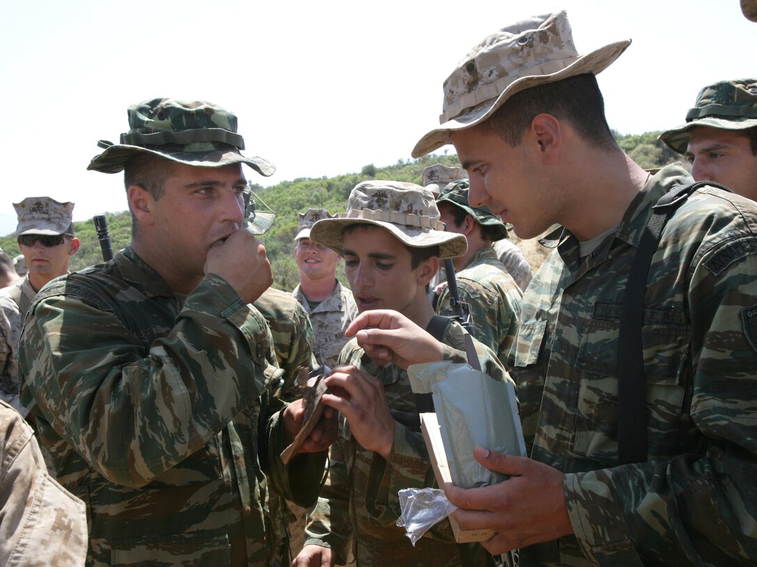 Greek Marines get a chance to taste Meals Ready-to-Eat they received from U.S. Marines at Melissatika training area outside Volos, Greece, June 11, 2009. The Marines are assigned to Battalion Landing Team, 3rd Battalion, 2nd Marine Regiment, 22nd Marine Expeditionary Unit.